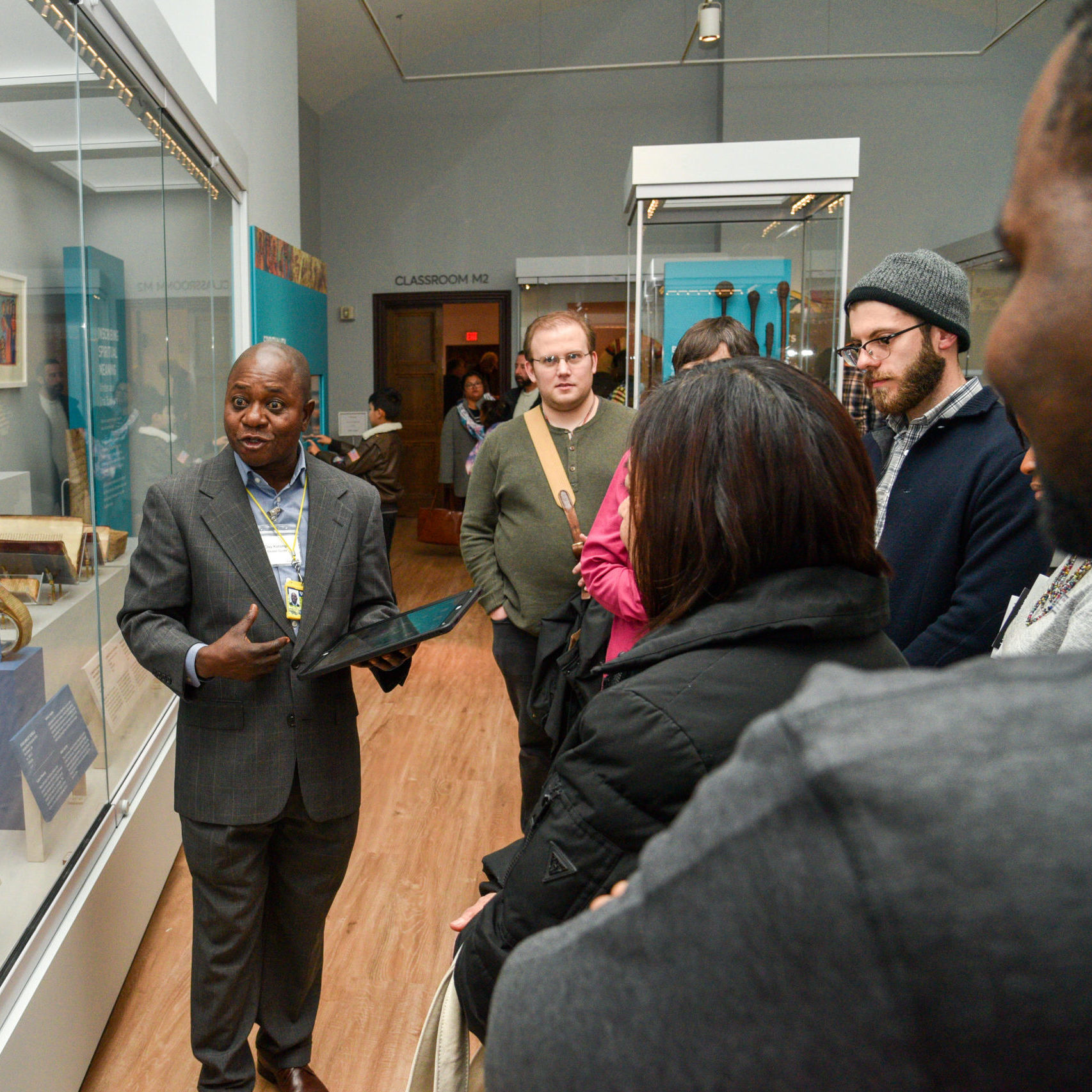 A museum tour guide speaking to a group of visitors at the Penn Museum